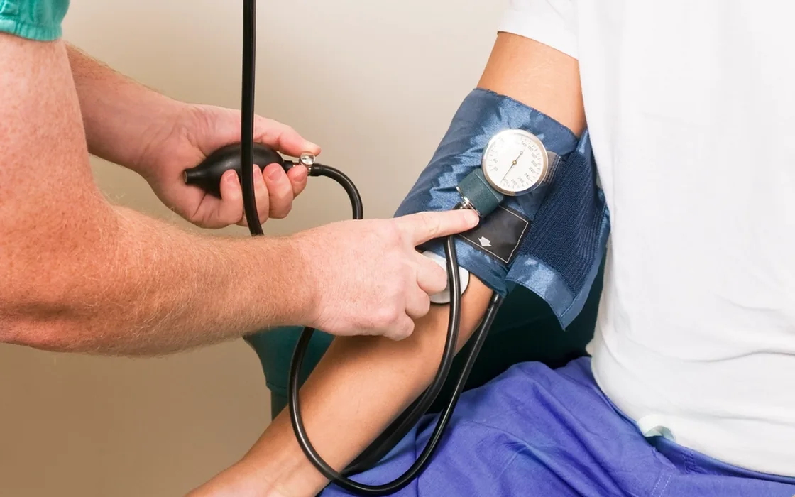 A clinician measuring a patient's blood pressure